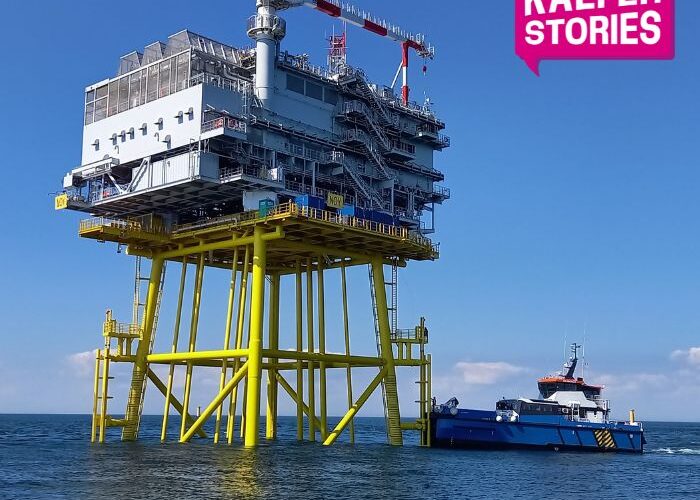 Substation with docked boat at sea