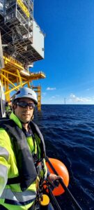 Raphael standin on board of the ship, next to the substation, in full PPE